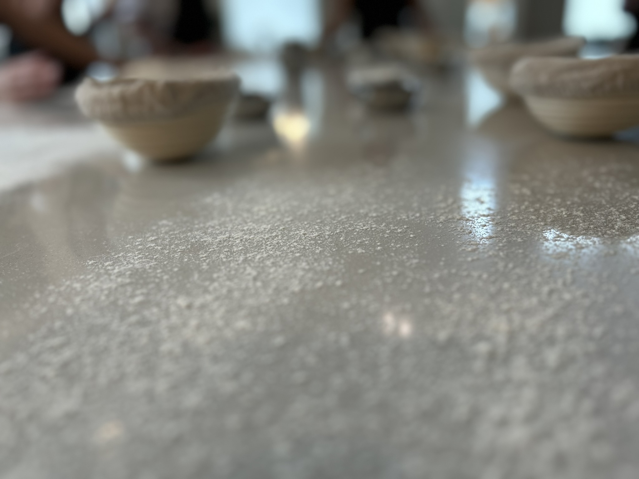 Floured counter with proofing baskets