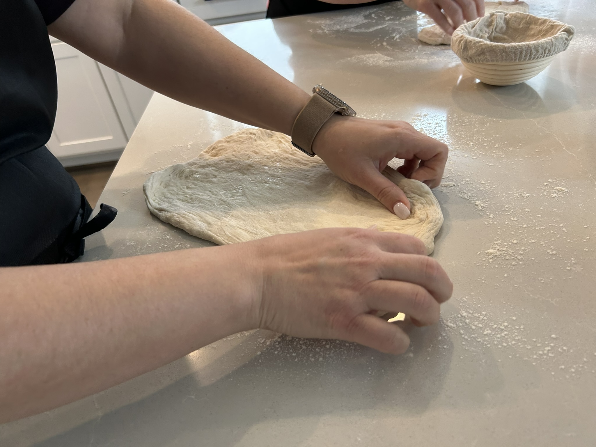 Hands folding dough