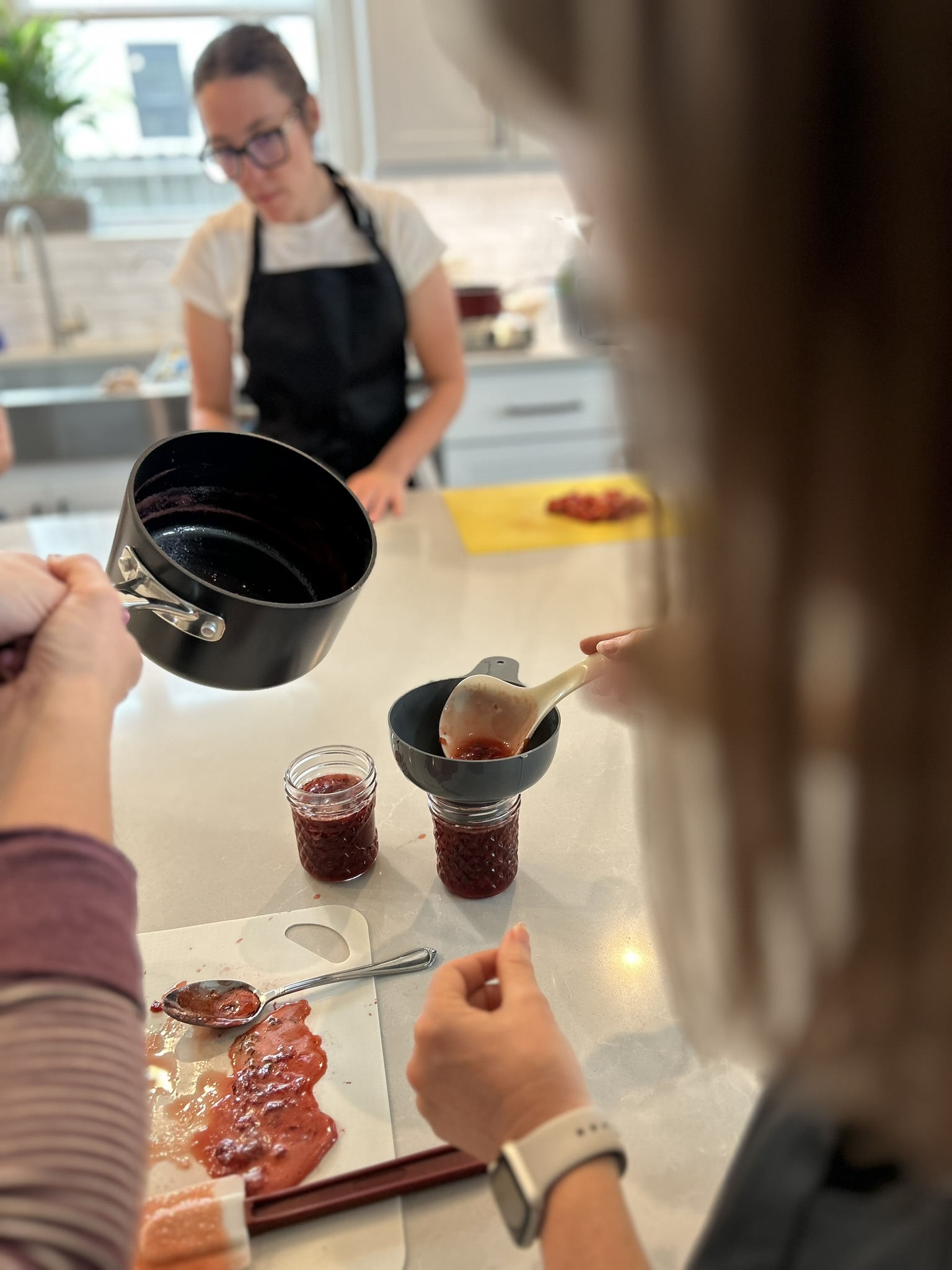 Ladling jam into mason jars