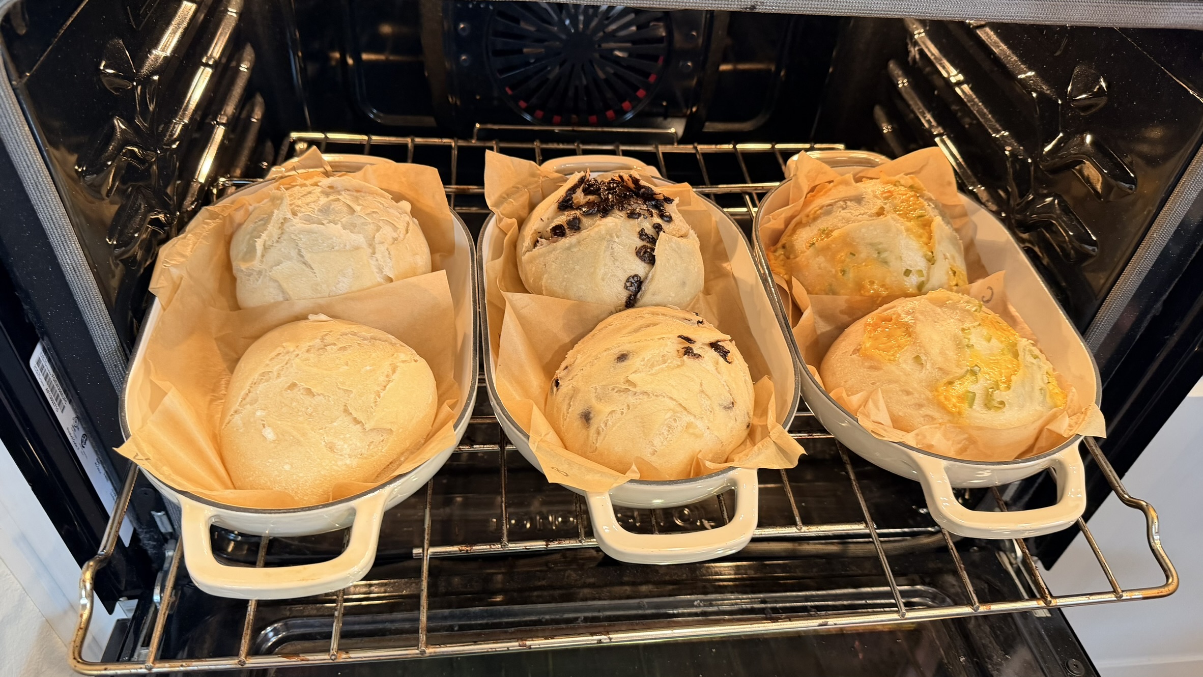 Six sourdough loaves in three Dutch ovens in the oven