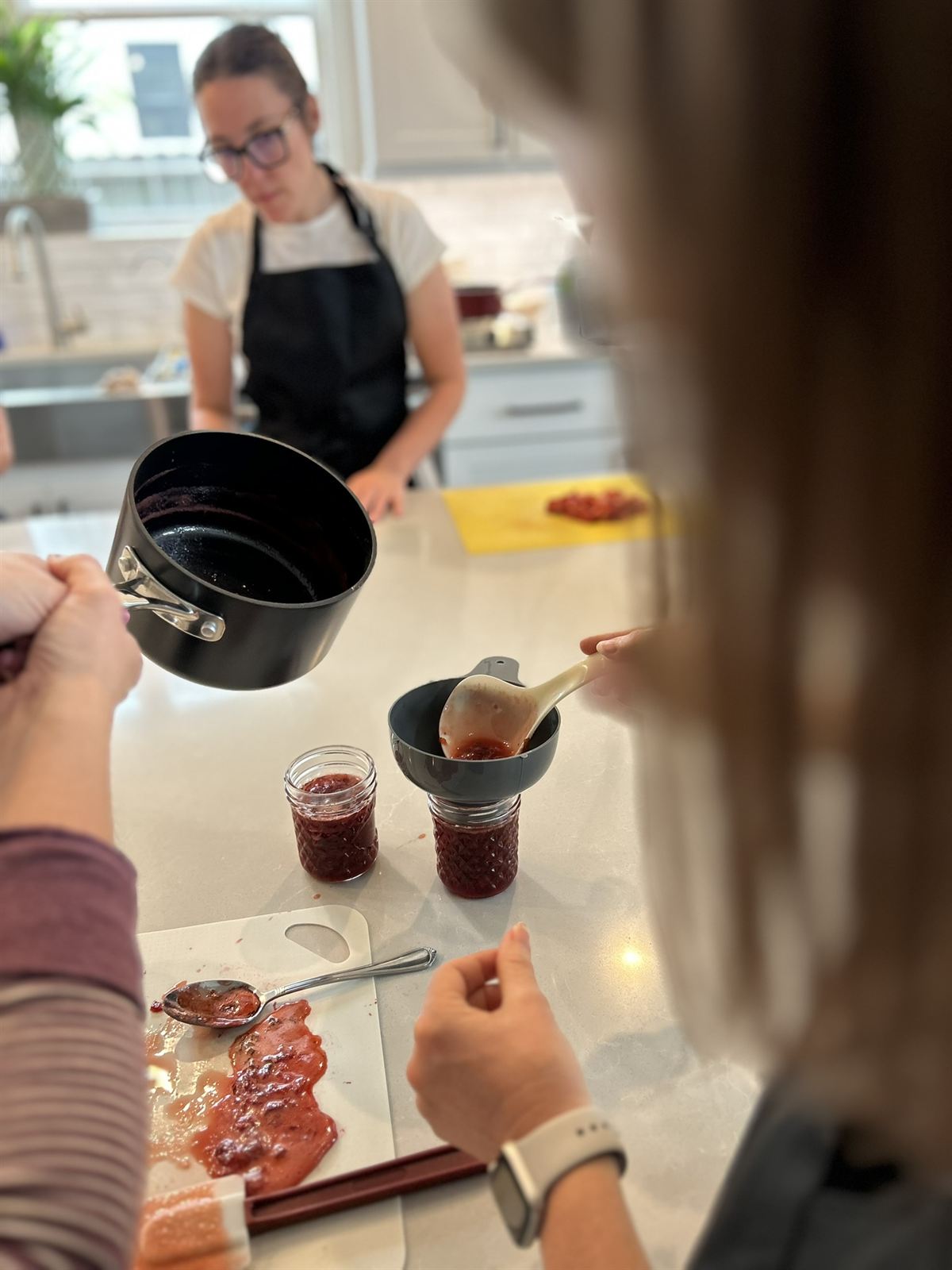 Ladling jam into mason jars
